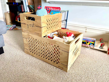 Wooden toy chest with toys on beige carpet in a lounge.