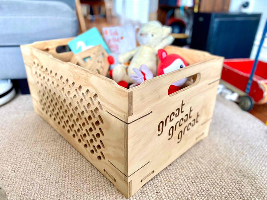 Locally made wooden toy chest filled with toys