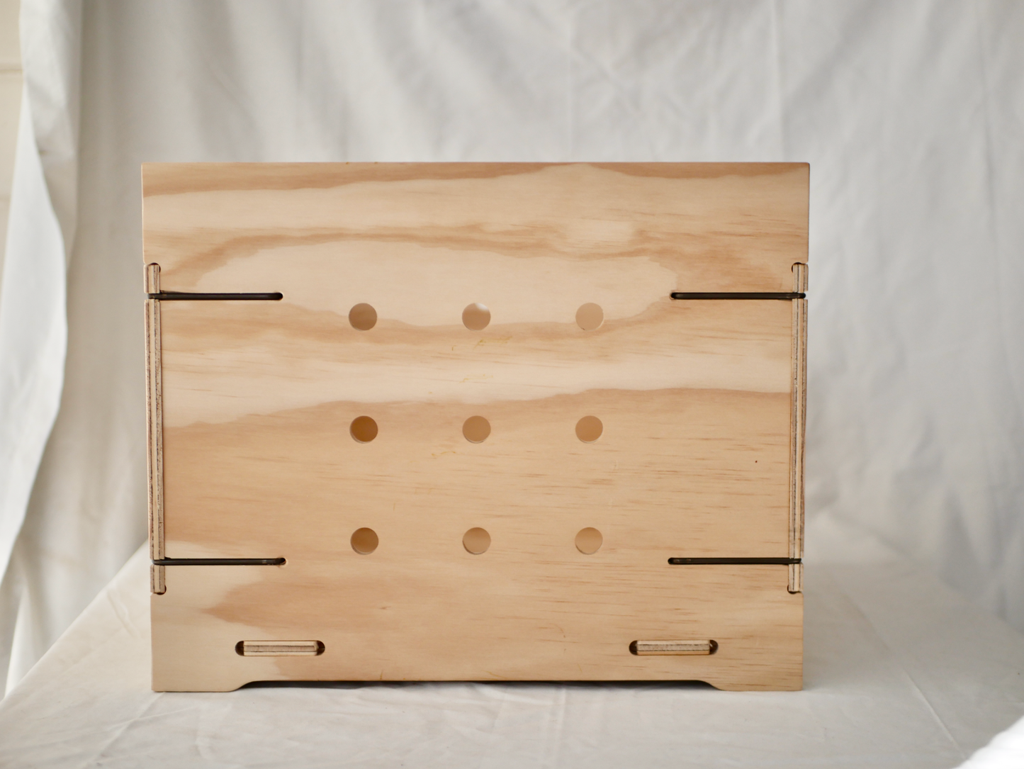 NZ-made vinyl storage box with wooden finish, designed for durability and style, featuring dust-reducing holes.