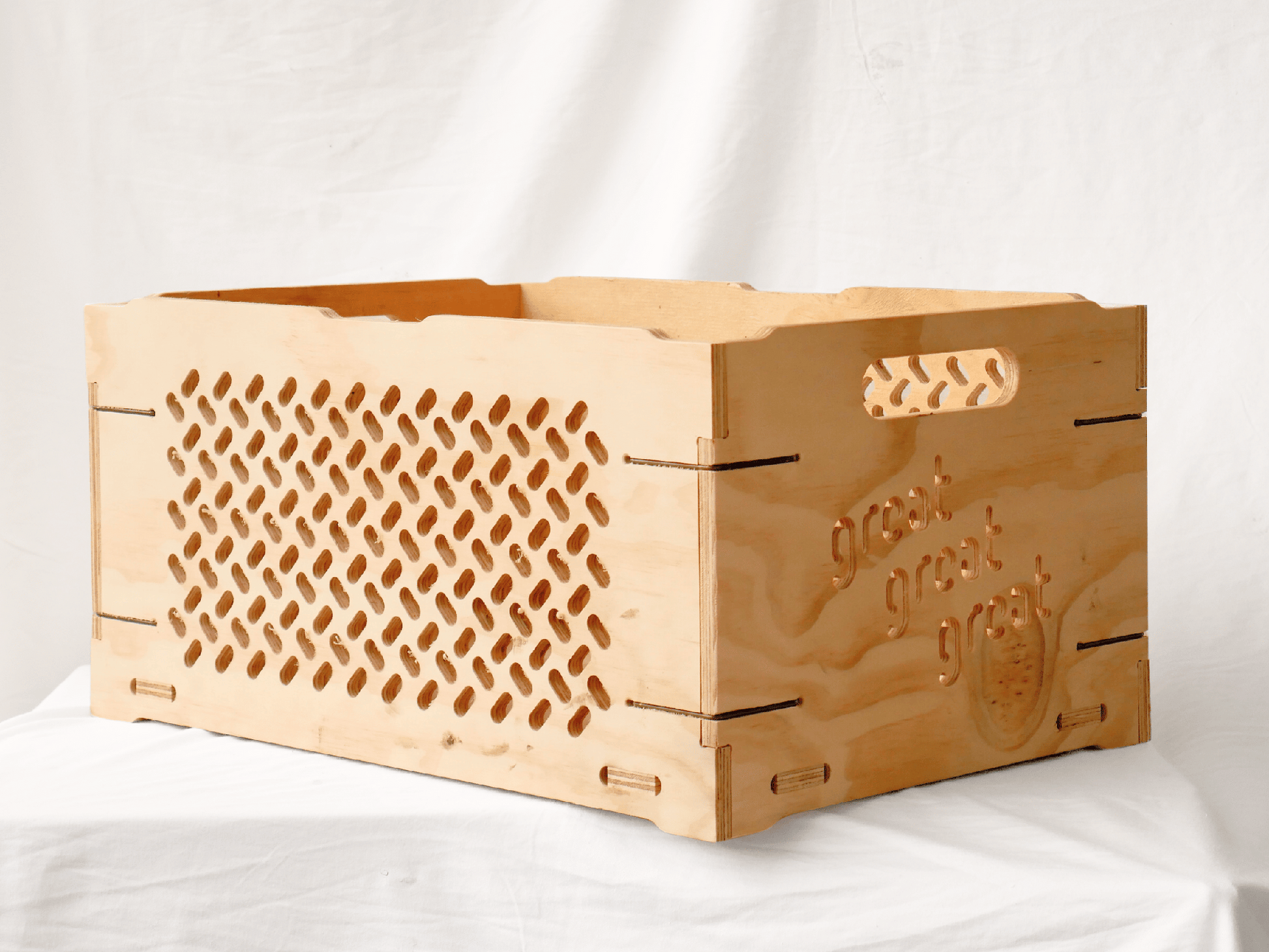Great Crate 60L firewood storage crate made of natural wood with a perforated design